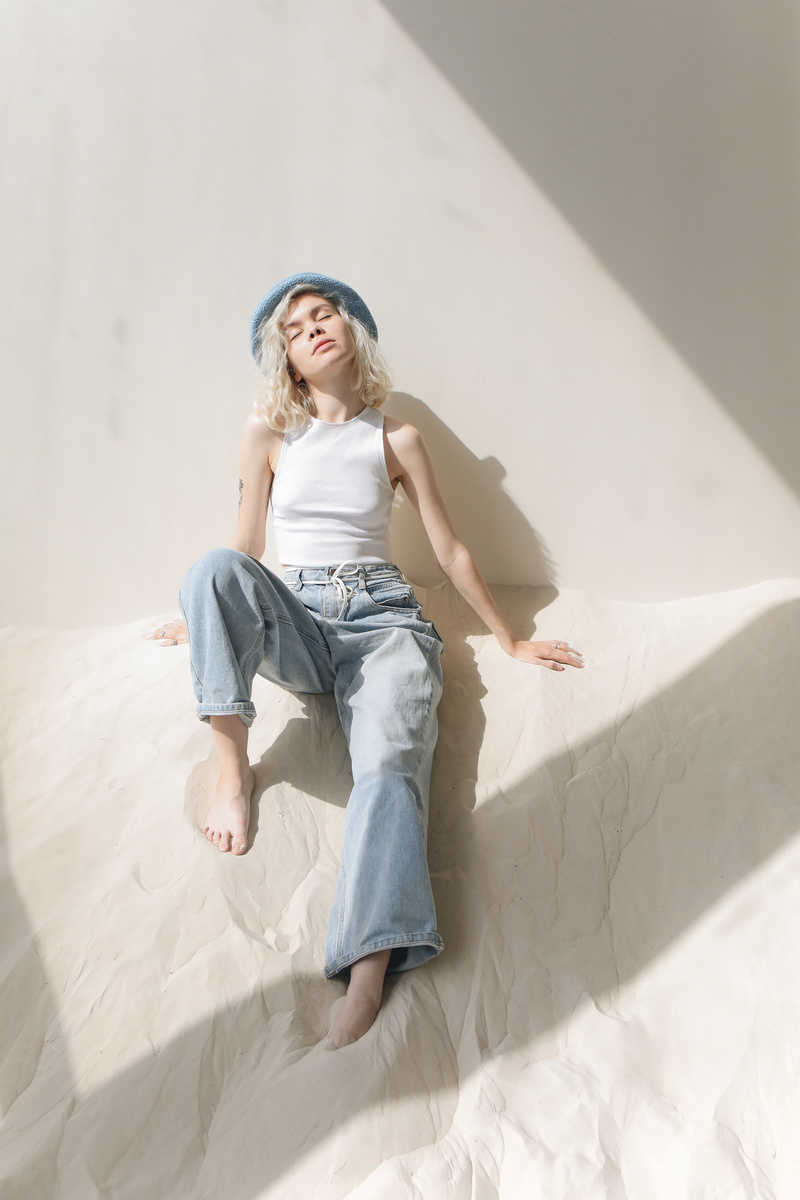Woman in White Top and Blue Denim Jeans